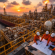 Engineers and FPSO at sunset